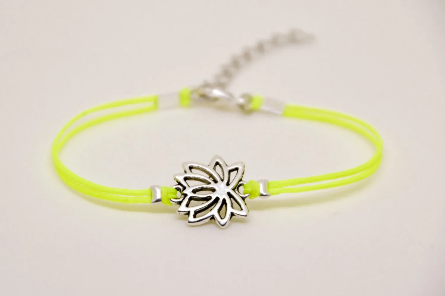 Neon yellow cord bracelet with silver lotus charm, yoga jewelry